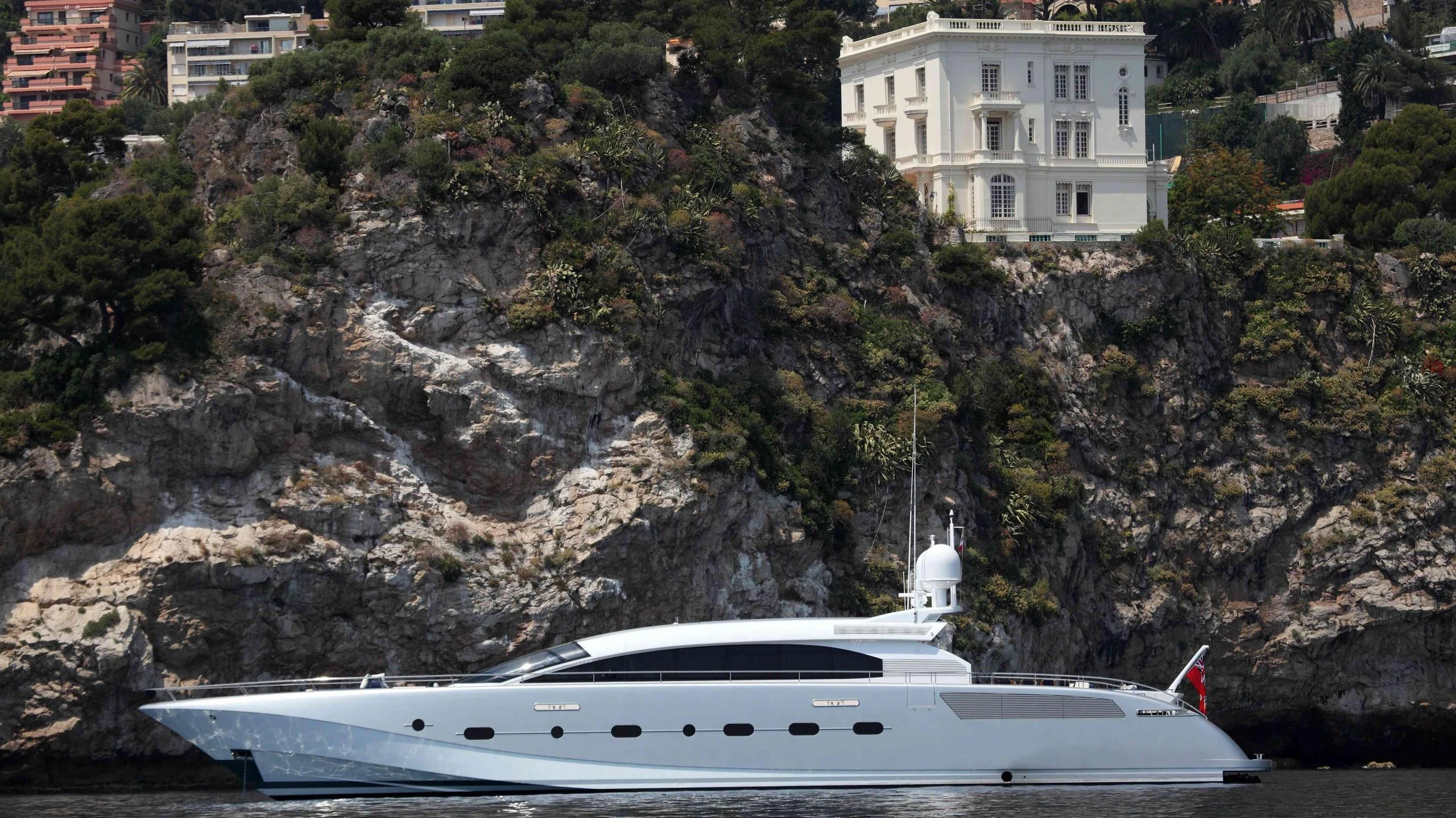 a white boat on a rocky shore aboard KESTREL Yacht for Sale