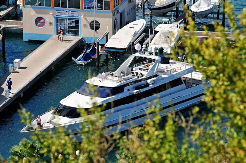 a large boat docked at a pier aboard AVALON Yacht for Sale