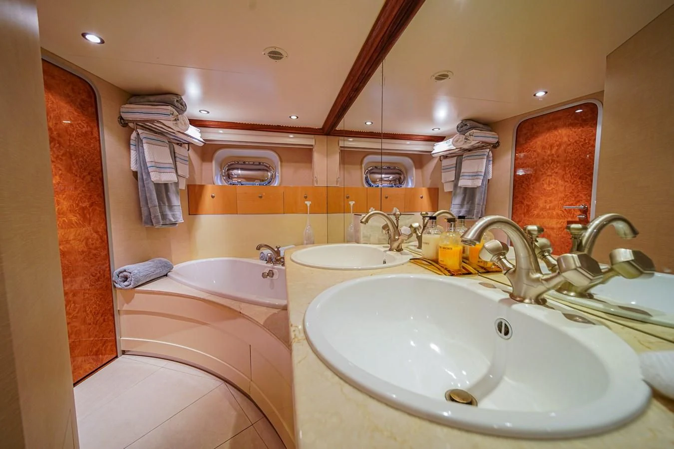 a bathroom with two sinks and a large mirror aboard AVALON Yacht for Sale
