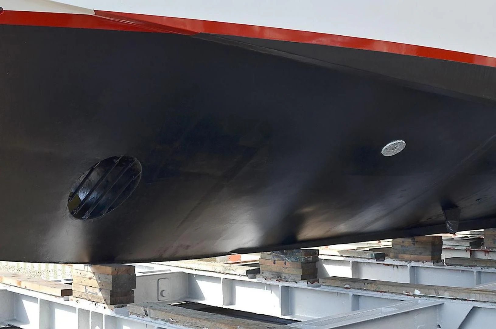 a black car with a red stripe aboard AVALON Yacht for Sale
