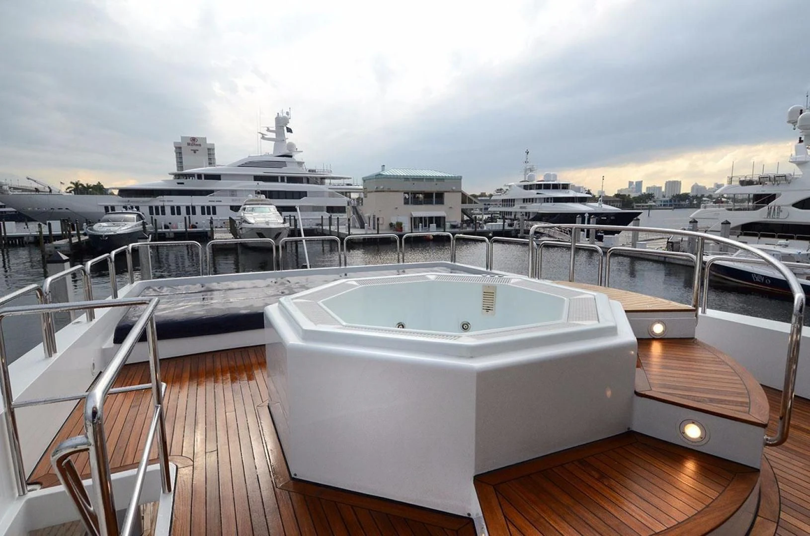 a large white pool on a deck overlooking a large ship aboard AVALON Yacht for Sale