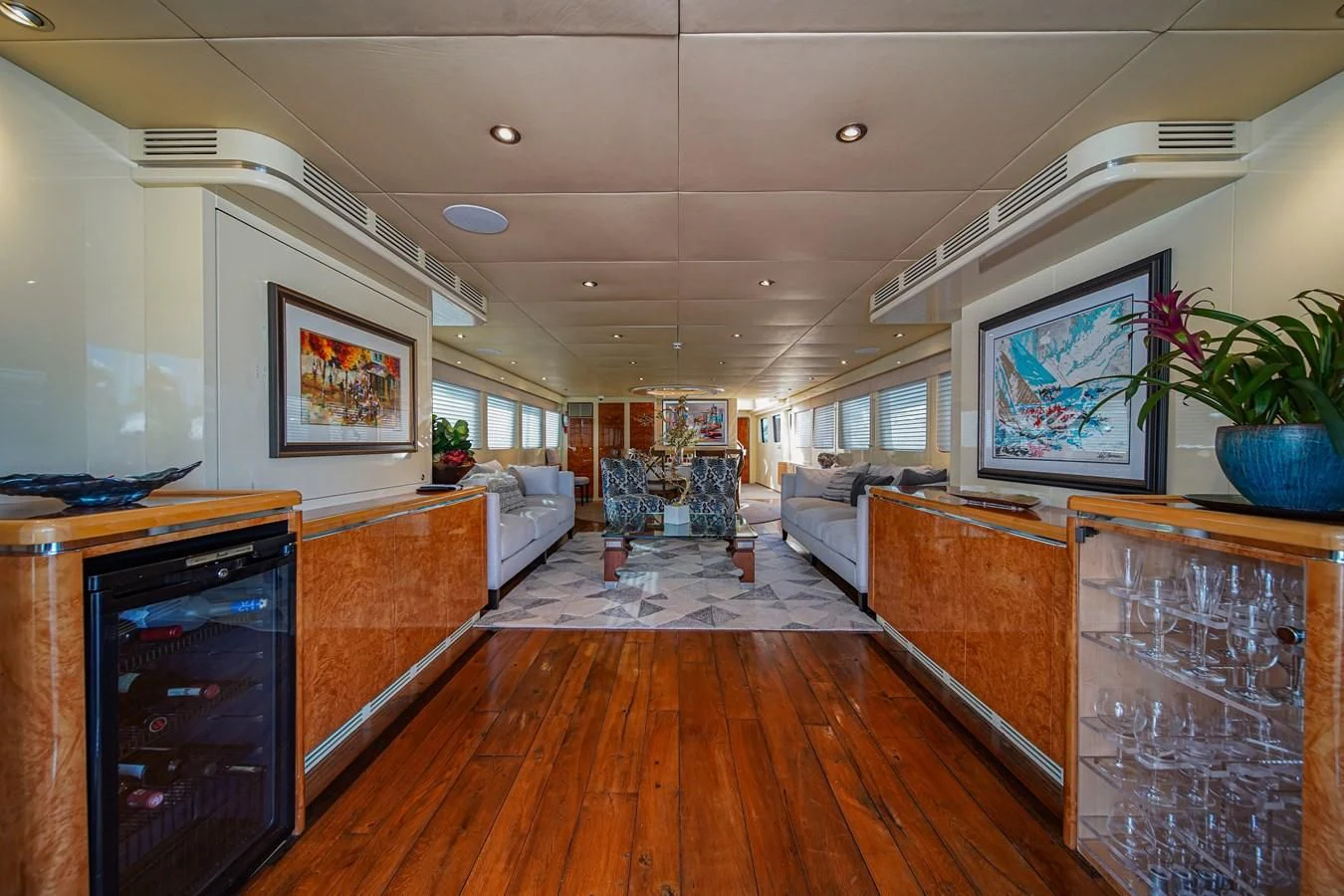 a living room with a wood floor aboard AVALON Yacht for Sale