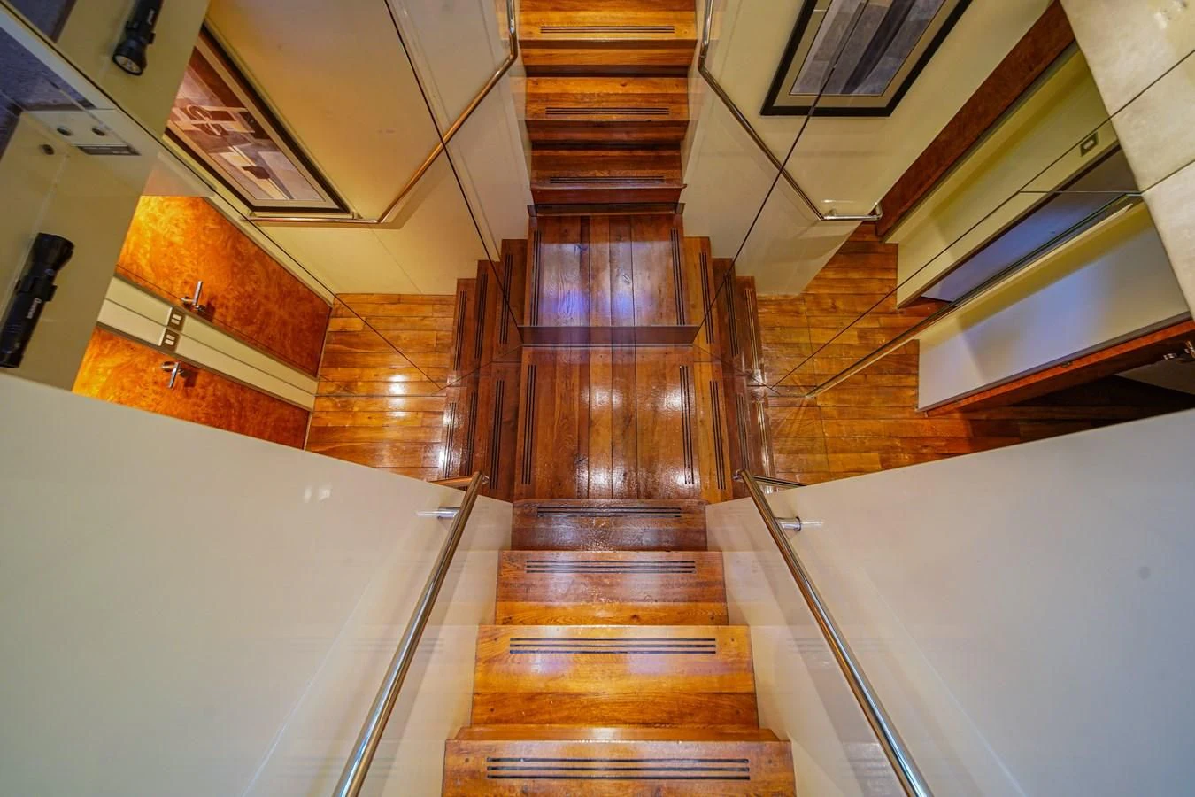 a long wooden staircase aboard AVALON Yacht for Sale
