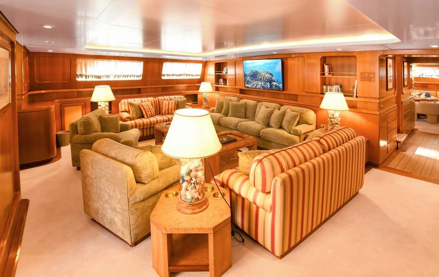 a living room with a couch and a tv aboard TAMARITA Yacht for Sale