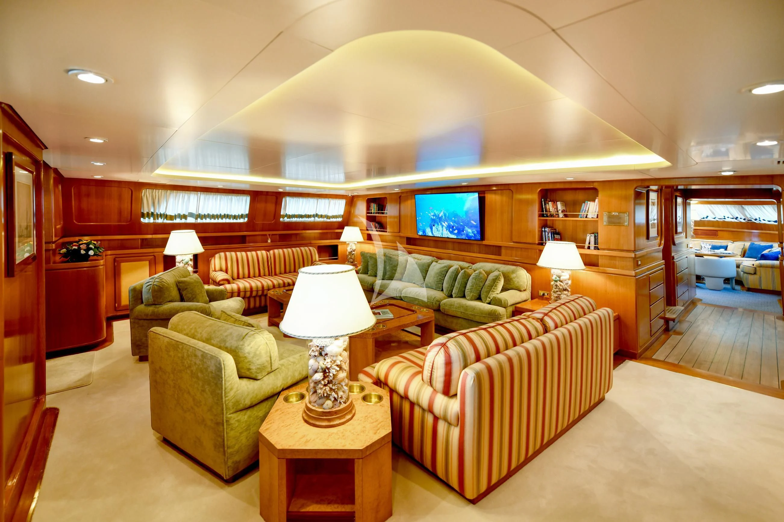 a living room with a large screen aboard TAMARITA Yacht for Sale