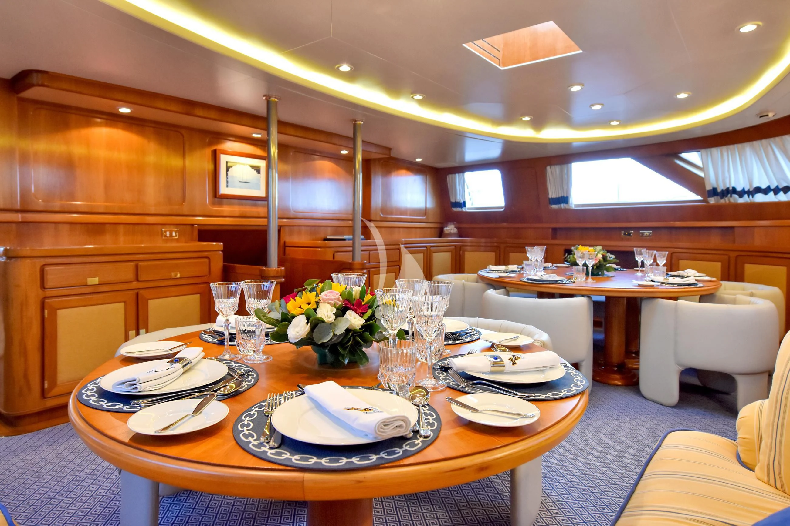 a table set with plates and glasses aboard TAMARITA Yacht for Sale