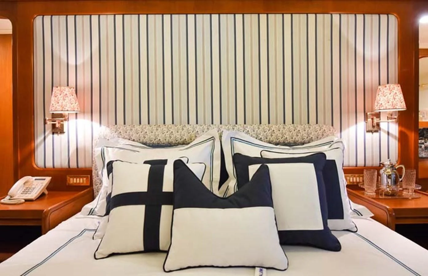 a bed with white sheets and pillows aboard TAMARITA Yacht for Sale