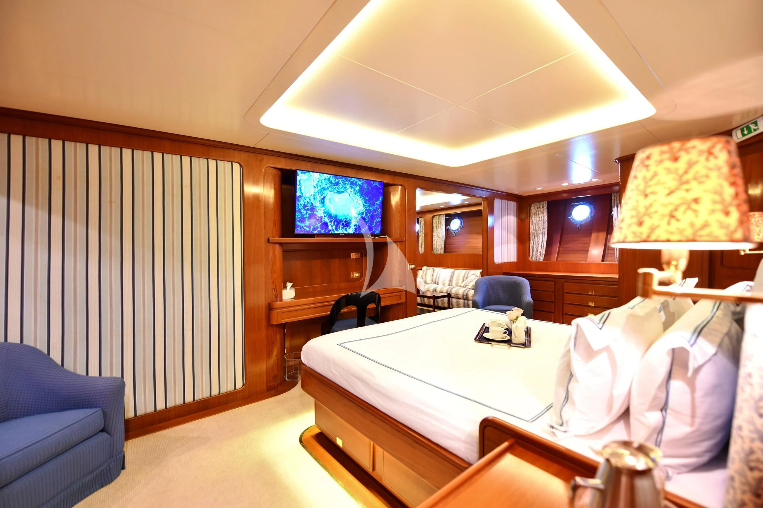 a bedroom with a large bed aboard TAMARITA Yacht for Sale