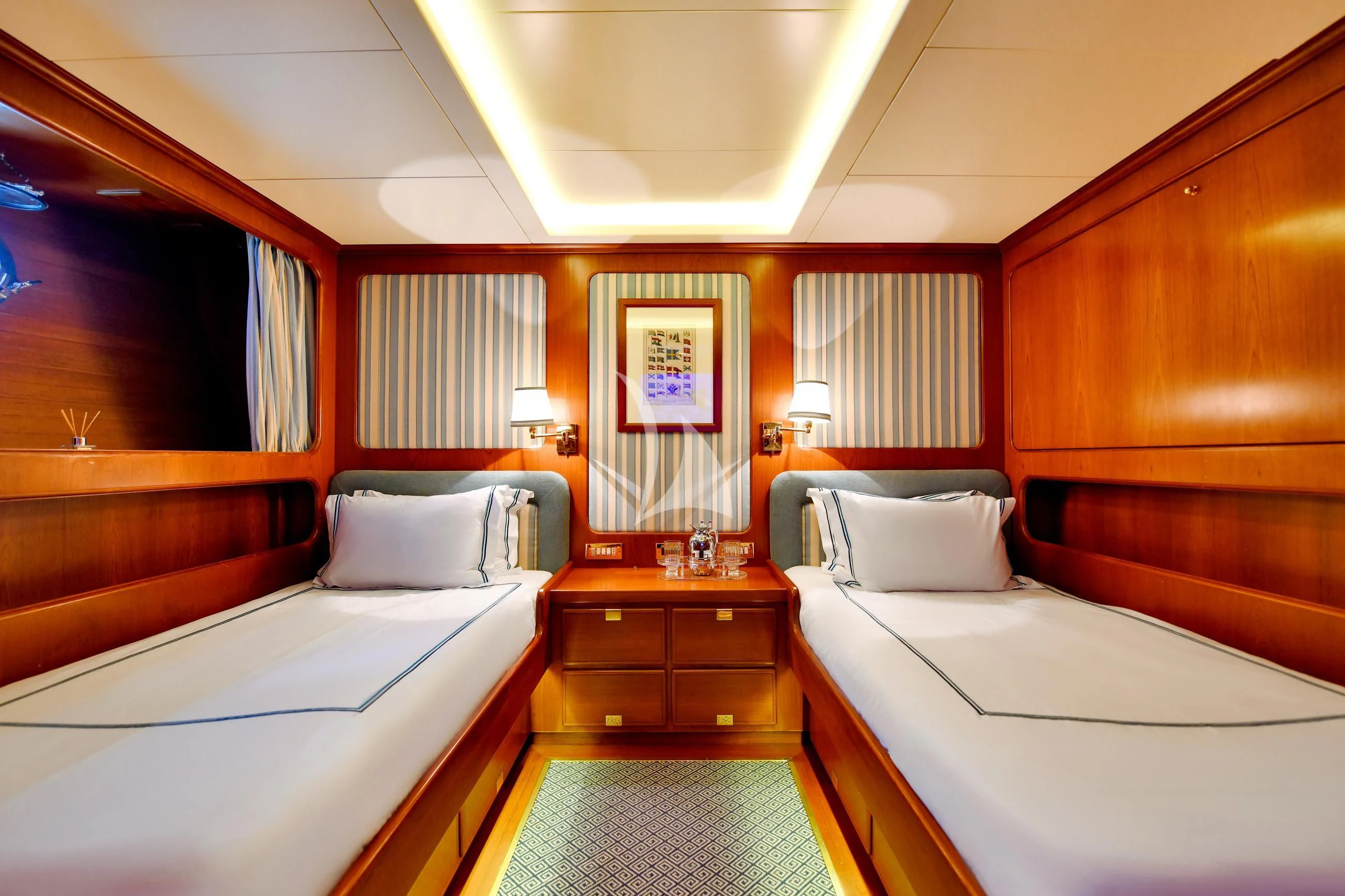 a room with beds and a dresser aboard TAMARITA Yacht for Sale
