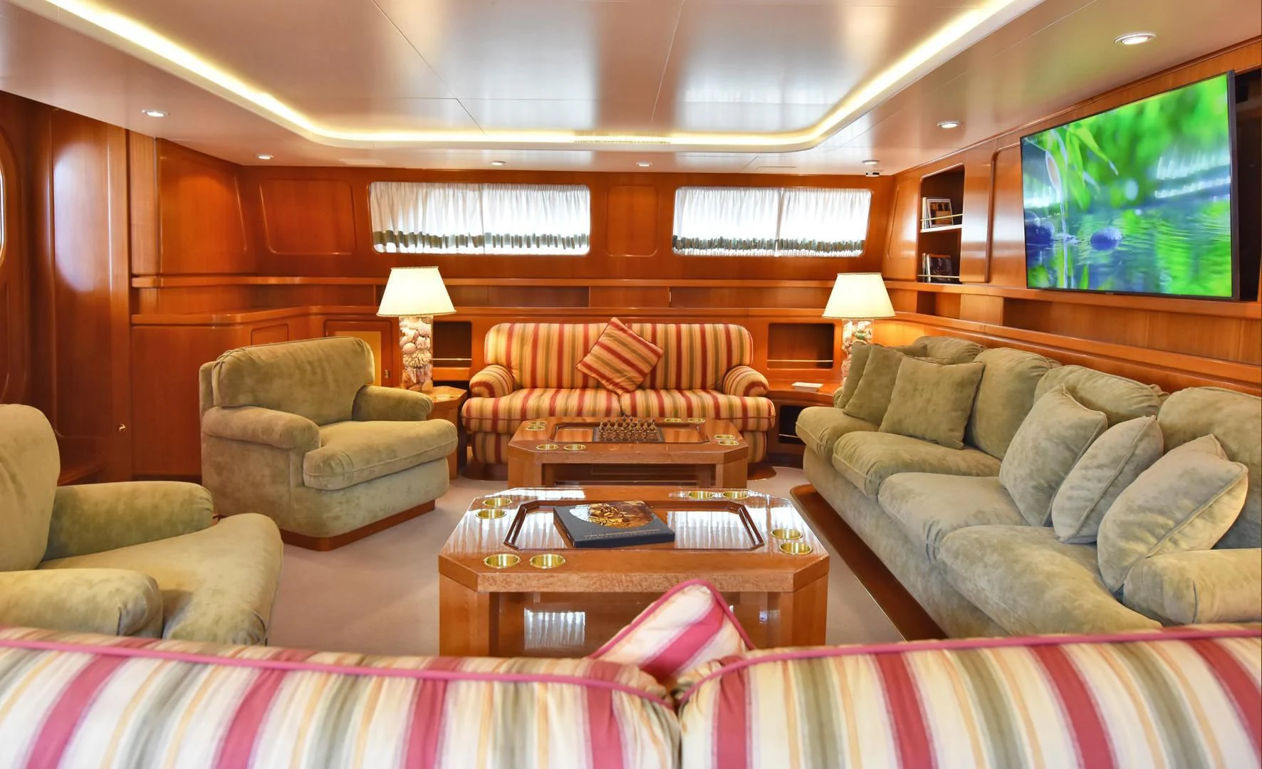 a living room with couches and a table aboard TAMARITA Yacht for Sale