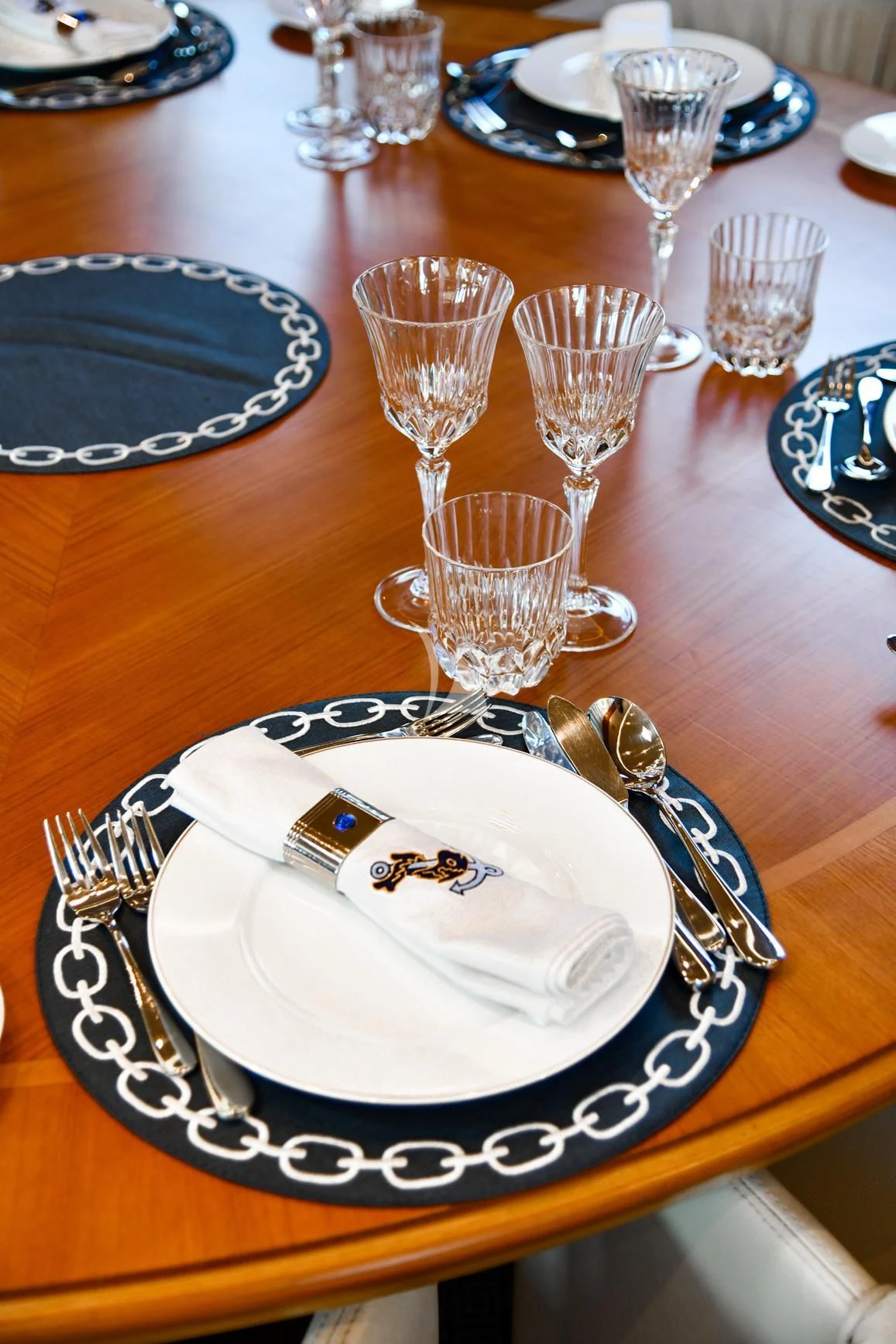 a table with plates and silverware aboard TAMARITA Yacht for Sale