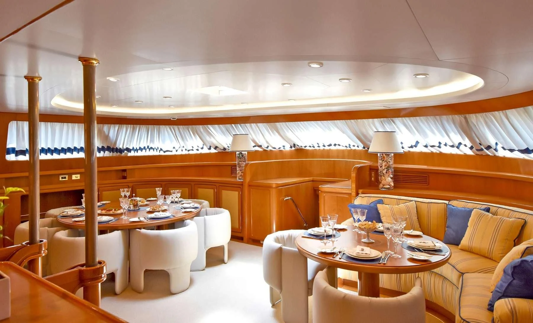 a room with a table and chairs aboard TAMARITA Yacht for Sale