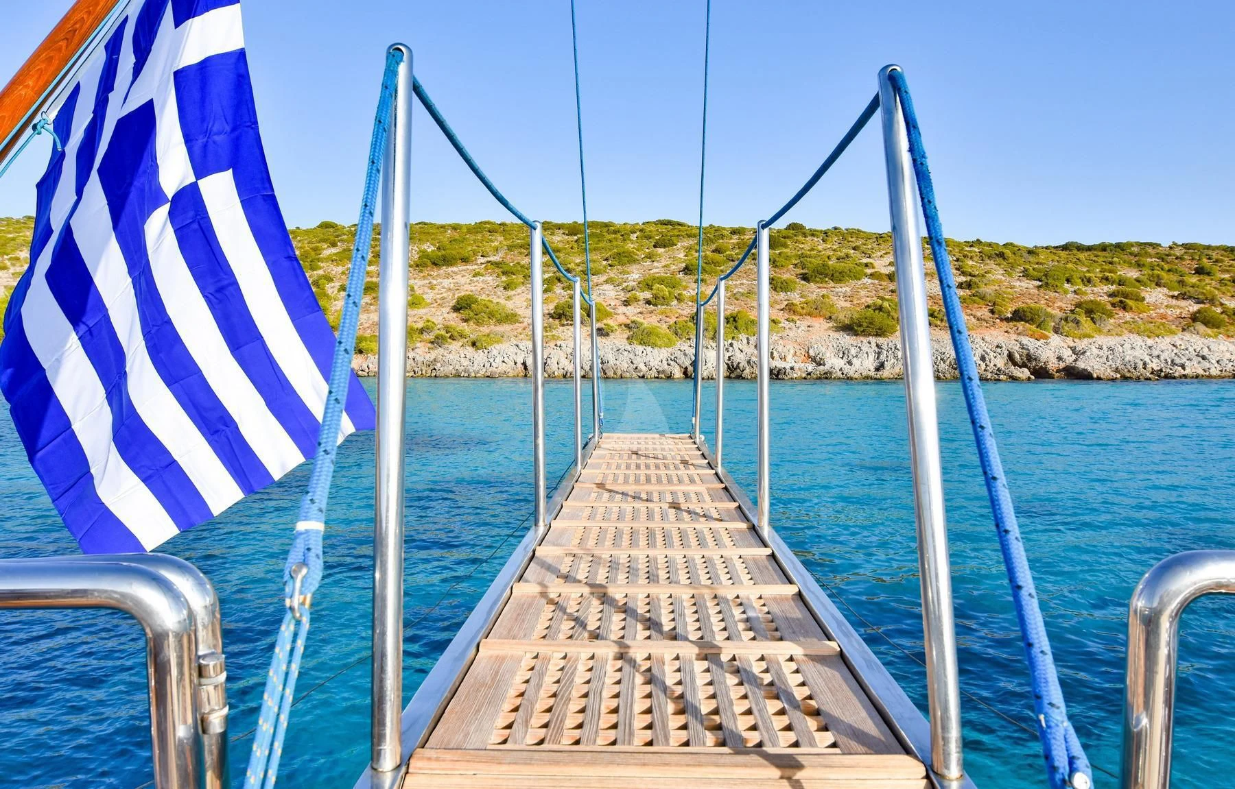 a wooden dock with a flag on it aboard TAMARITA Yacht for Sale