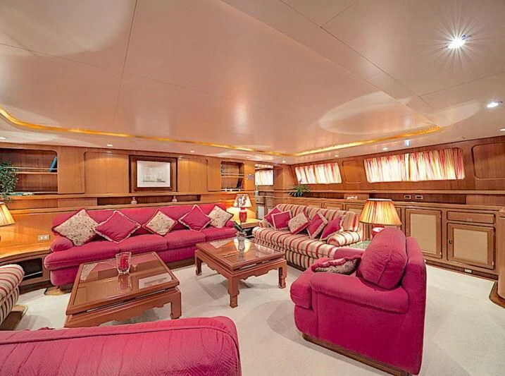 a living room with pink couches and a coffee table aboard TAMARITA Yacht for Sale