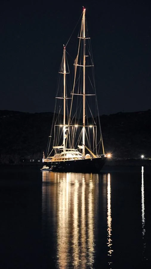 a sailboat at night aboard TAMARITA Yacht for Sale