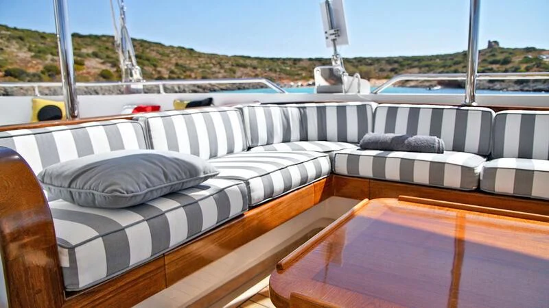 a couch on a deck aboard TAMARITA Yacht for Sale