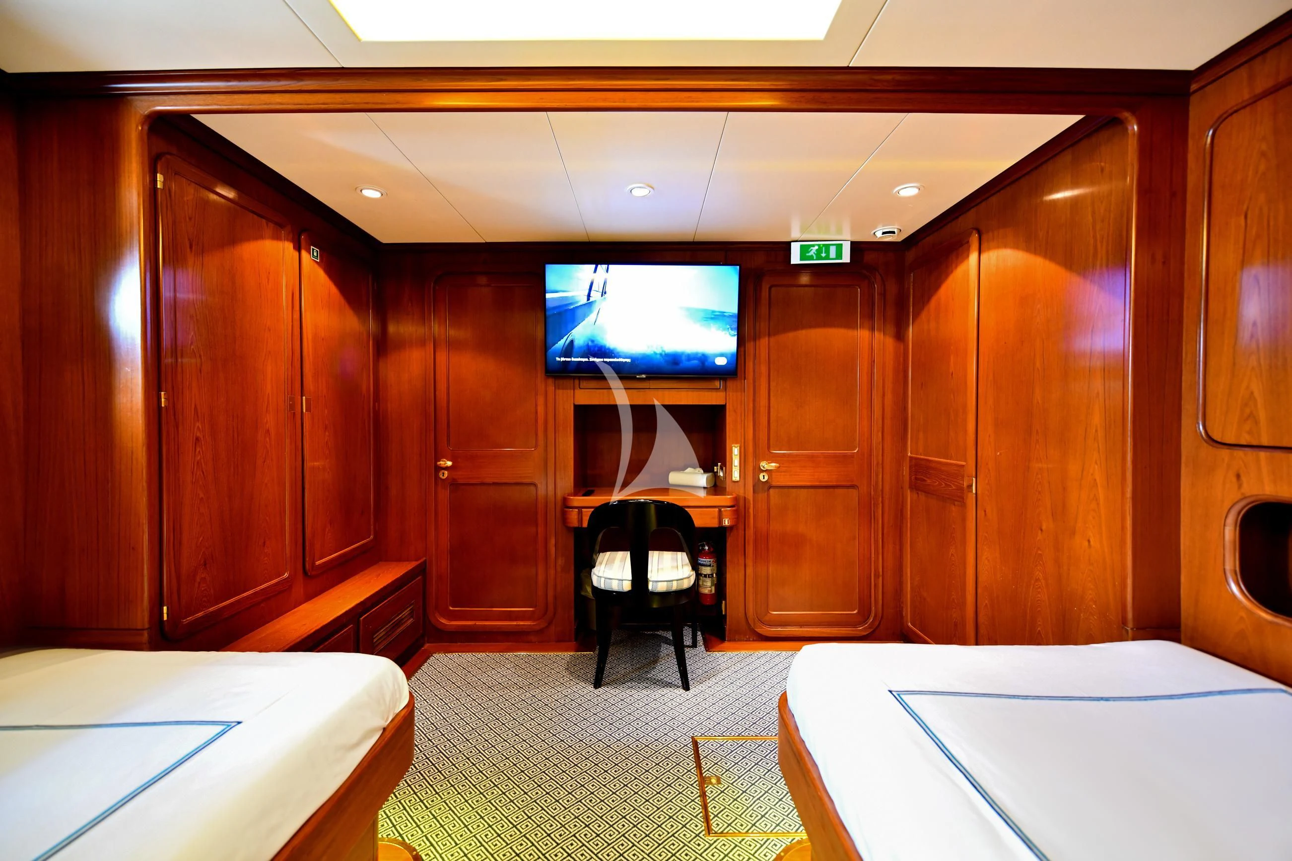 a room with a tv and a table aboard TAMARITA Yacht for Sale