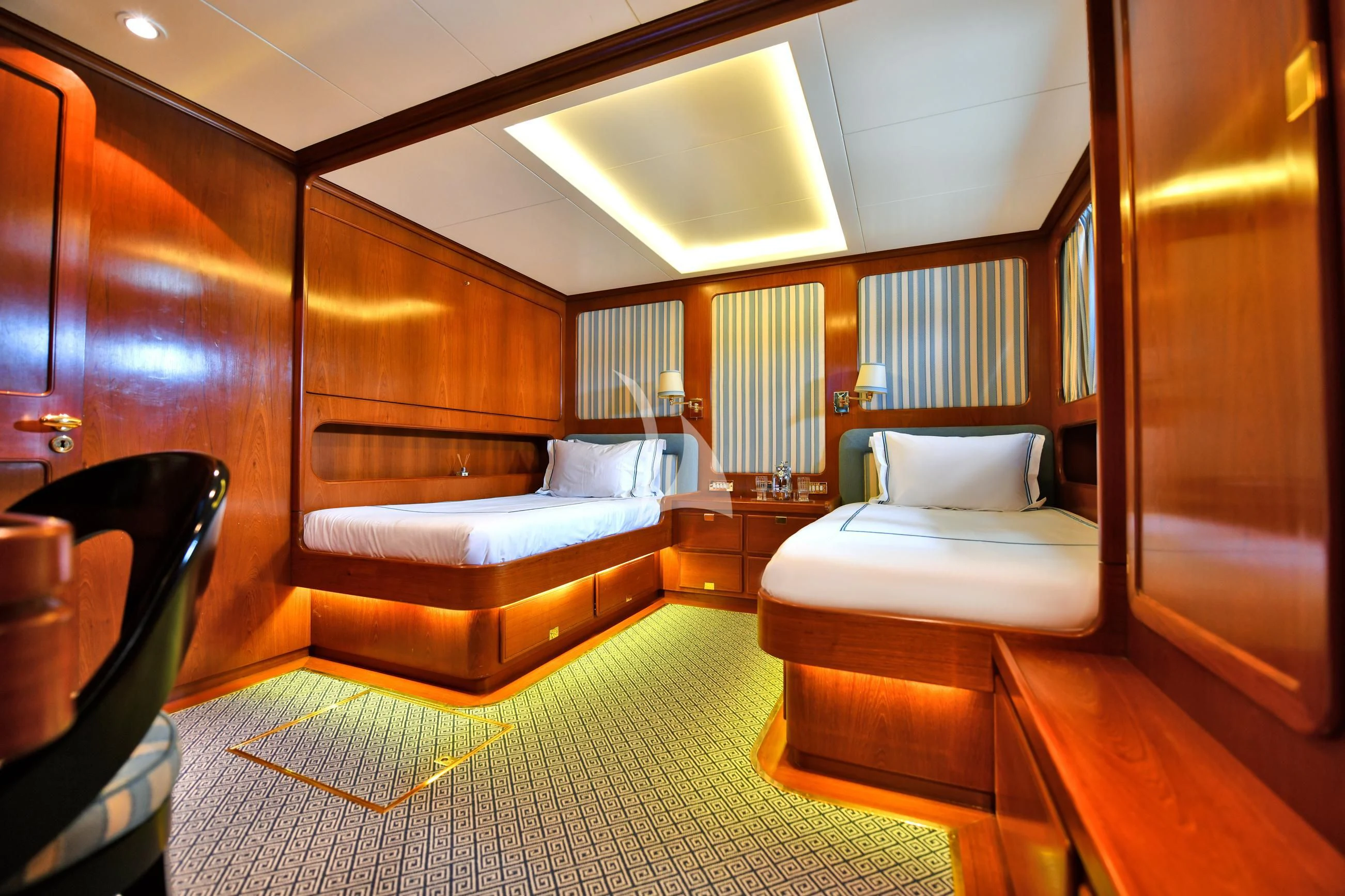 a room with a bed and a chair aboard TAMARITA Yacht for Sale