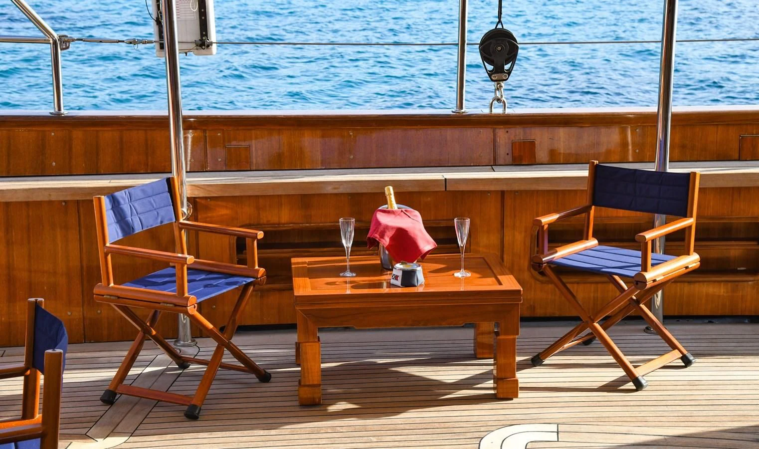 a table and chairs on a deck aboard TAMARITA Yacht for Sale