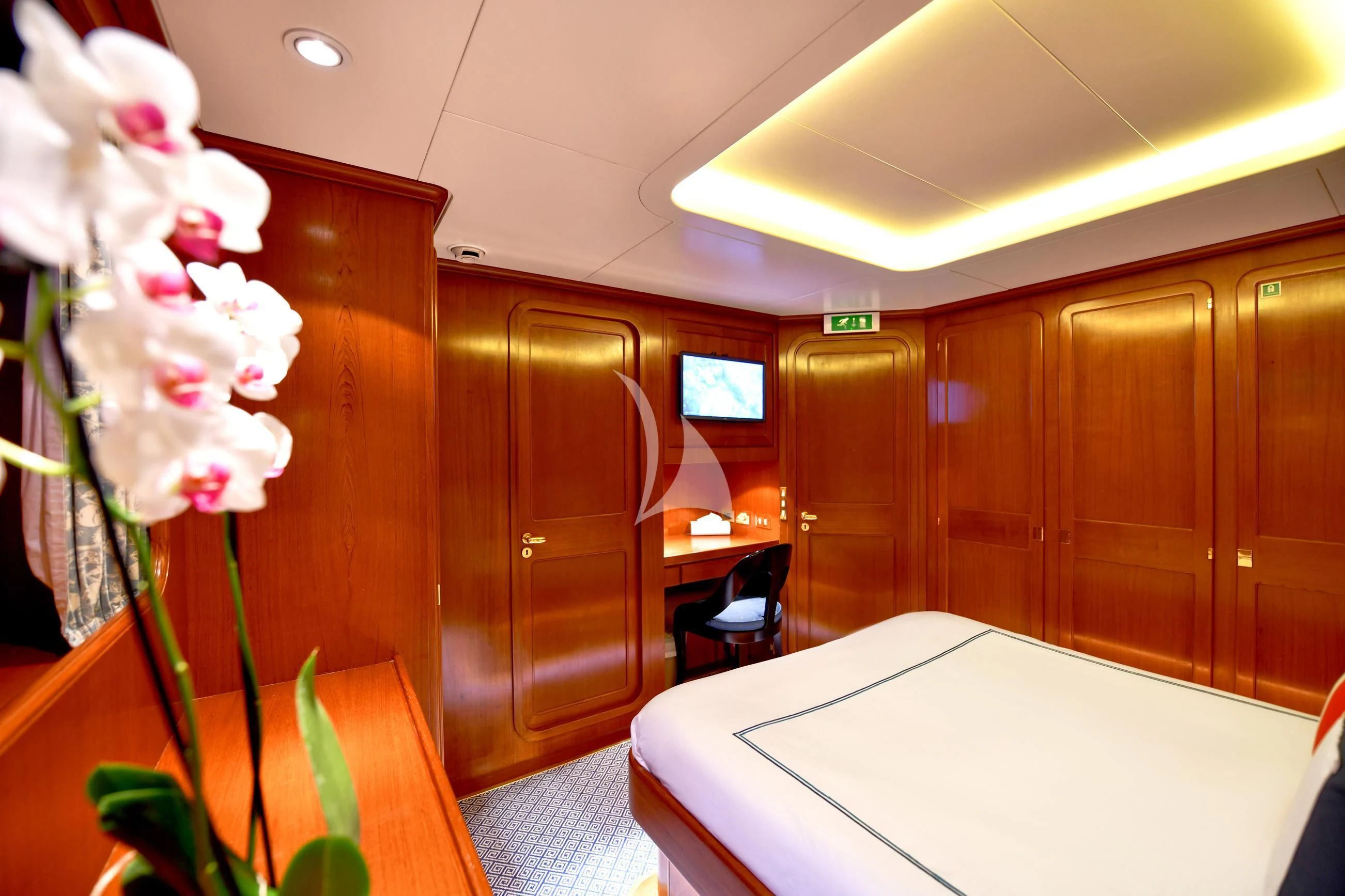 a room with a desk and a television aboard TAMARITA Yacht for Sale
