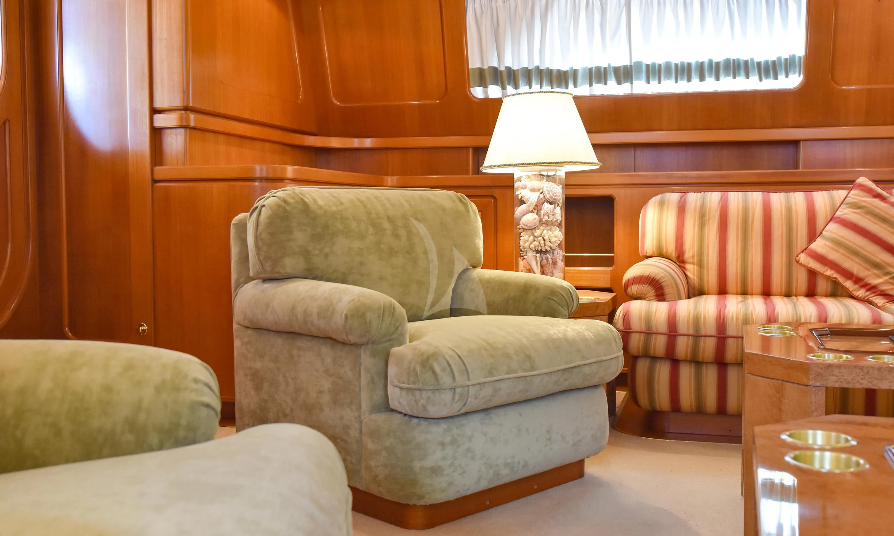 a living room with a couch and a lamp aboard TAMARITA Yacht for Sale