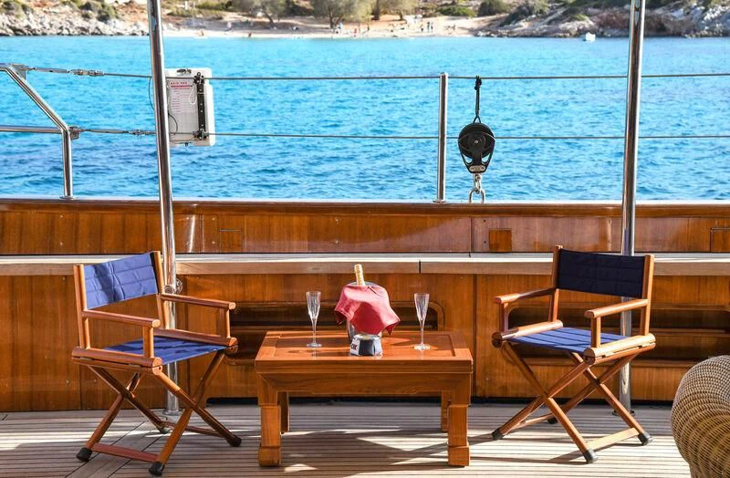 a table and chairs on a deck aboard TAMARITA Yacht for Sale