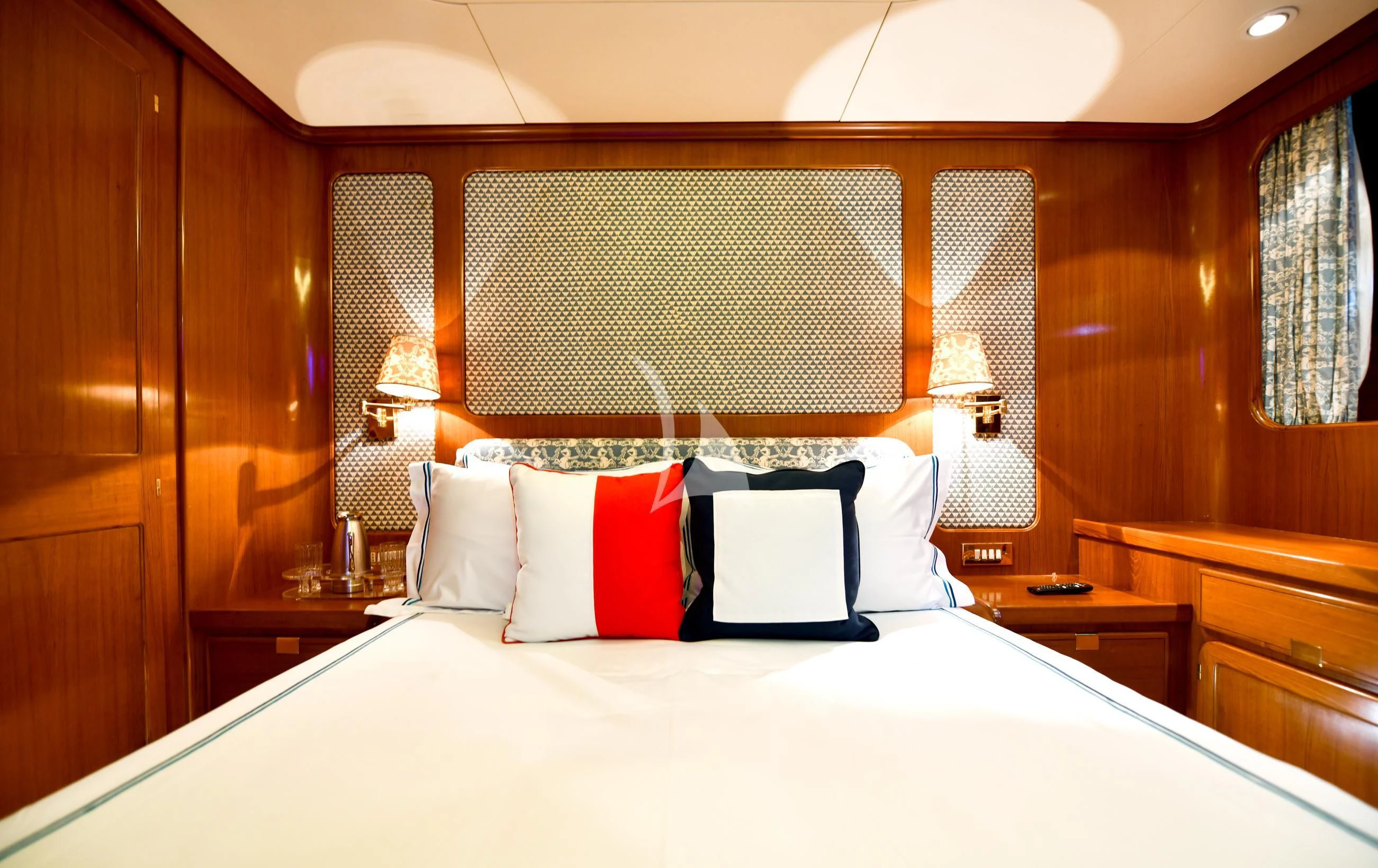 a bed with white sheets and pillows aboard TAMARITA Yacht for Sale