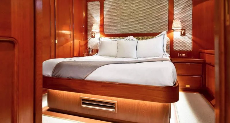 a bed with white sheets aboard TAMARITA Yacht for Sale