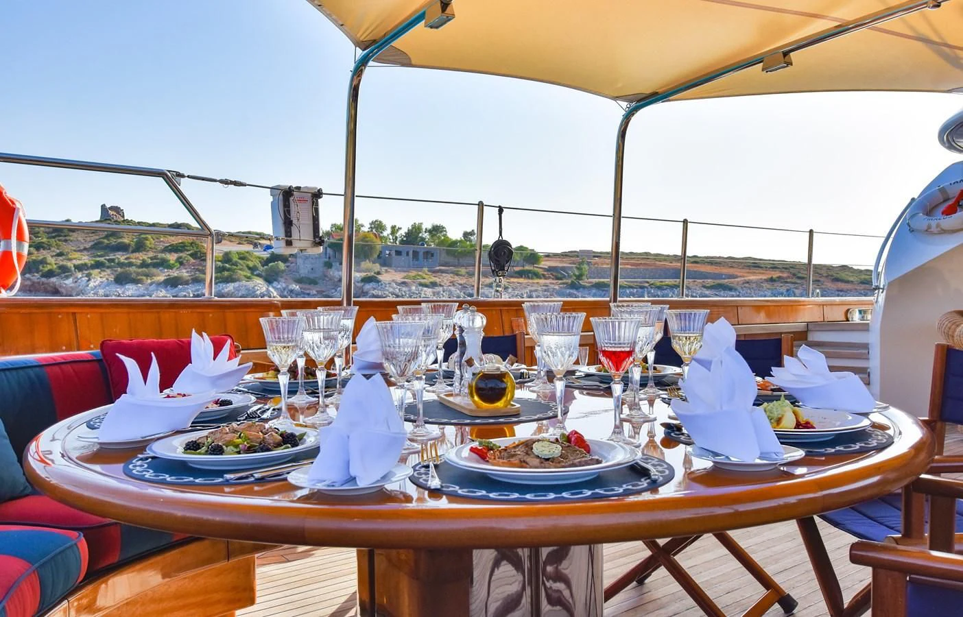 a table set with food and wine aboard TAMARITA Yacht for Sale