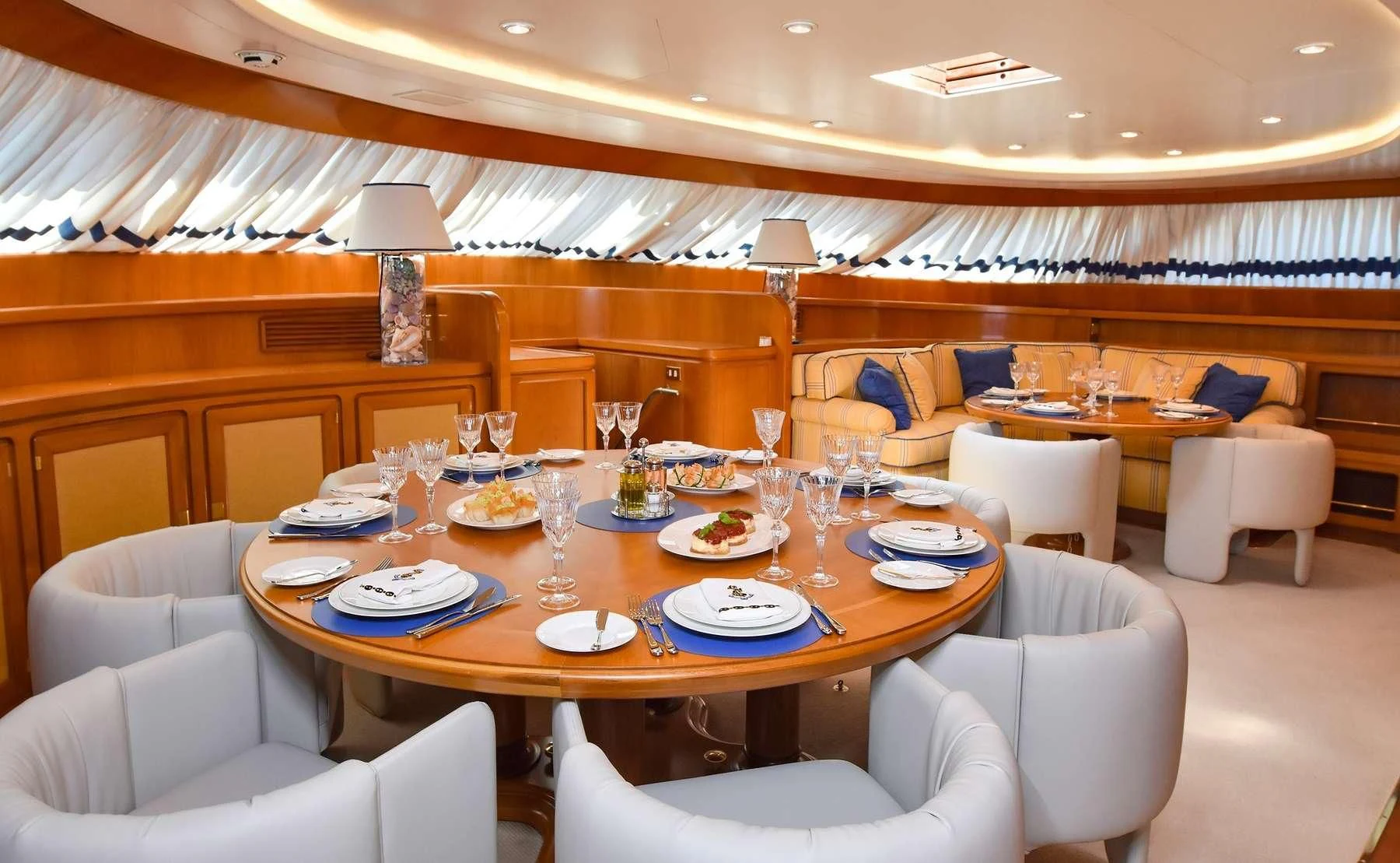 a dining room with a table set aboard TAMARITA Yacht for Sale