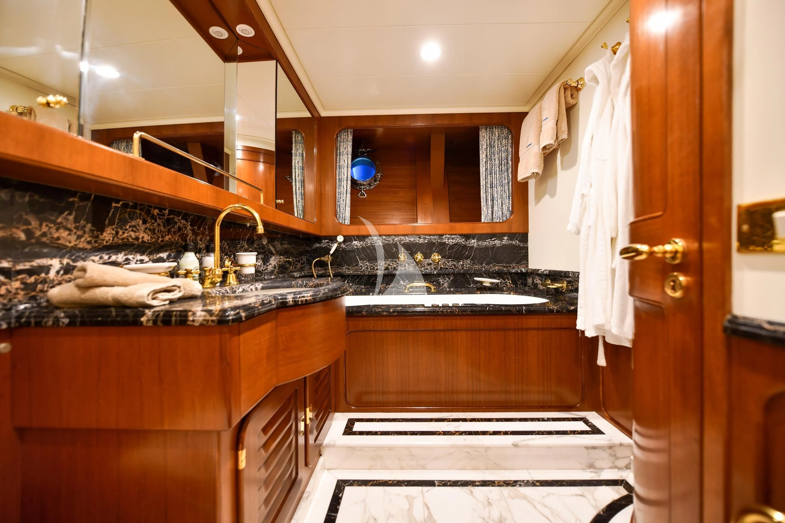 a kitchen with wooden cabinets aboard TAMARITA Yacht for Sale