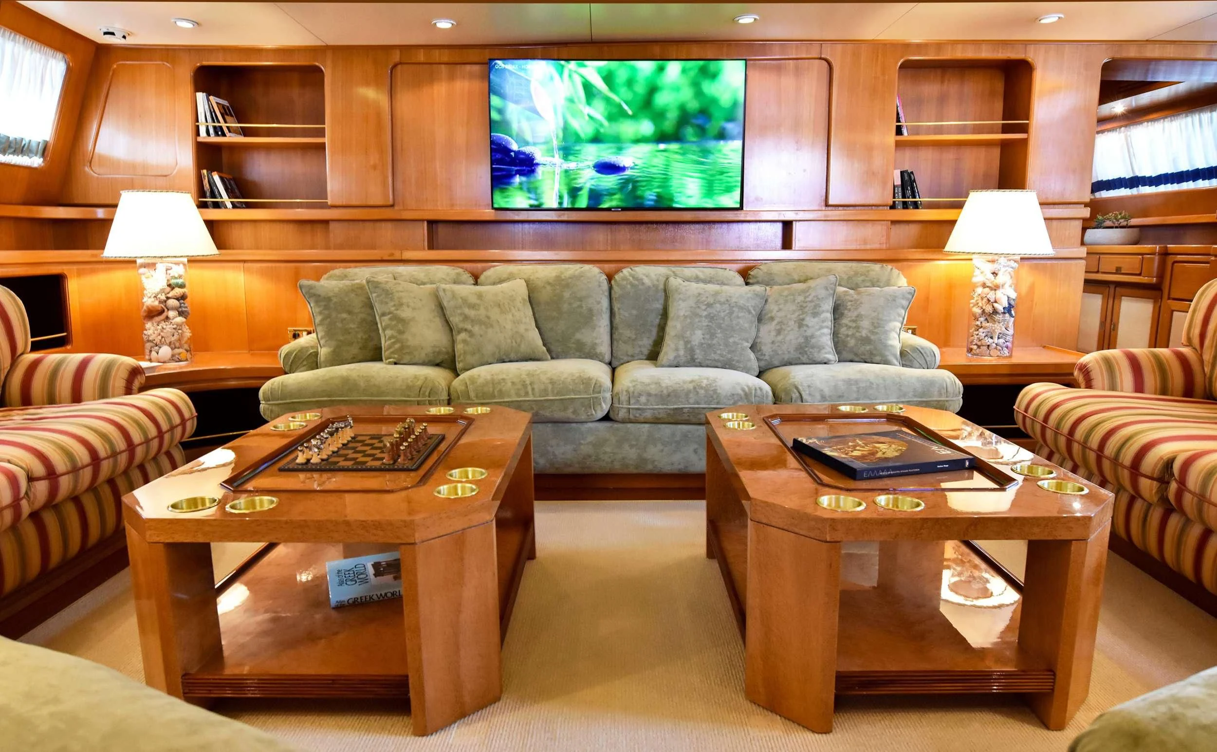 a living room with a couch and a coffee table aboard TAMARITA Yacht for Sale