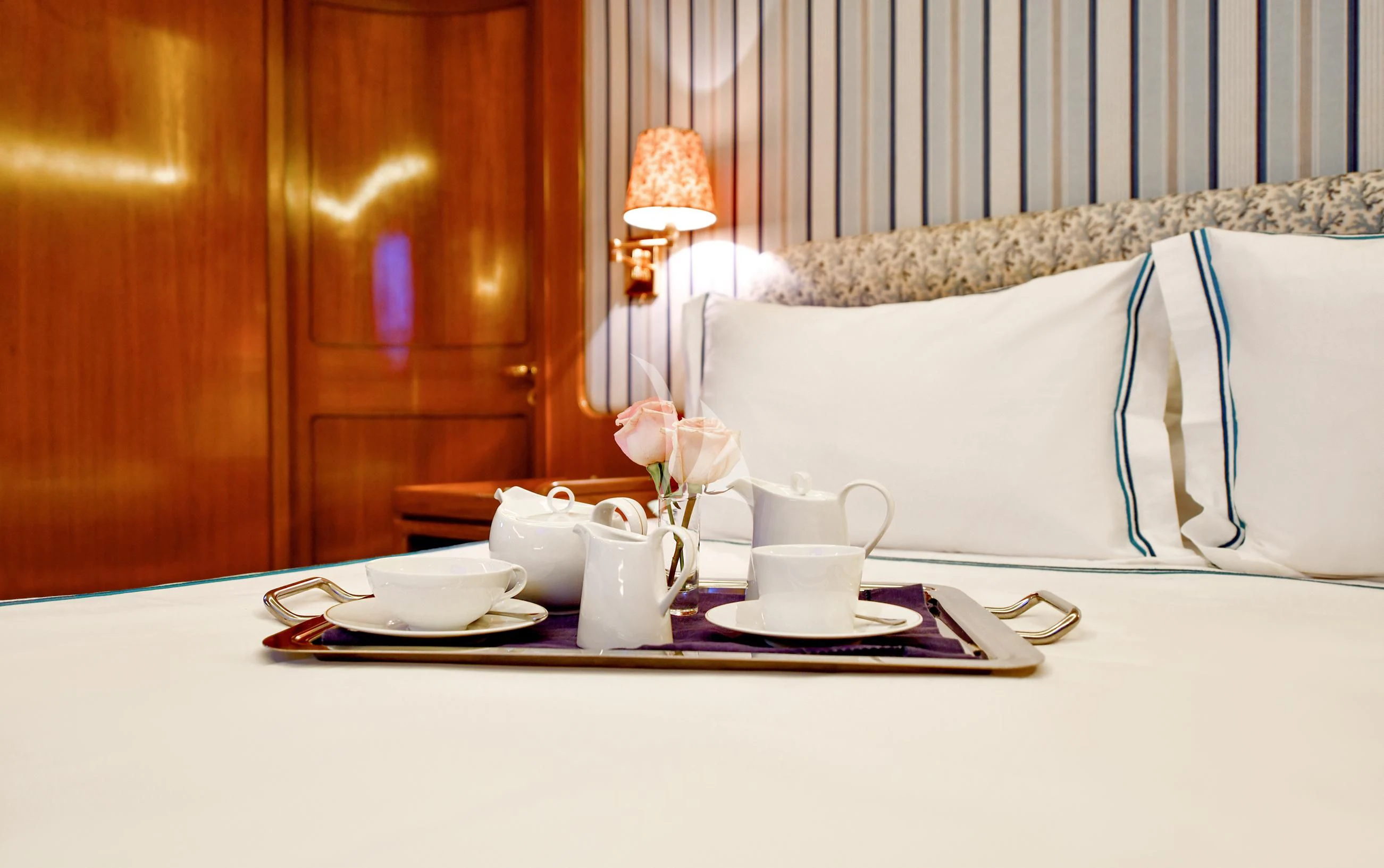 a table with a tea set and a white pillow on it aboard TAMARITA Yacht for Sale