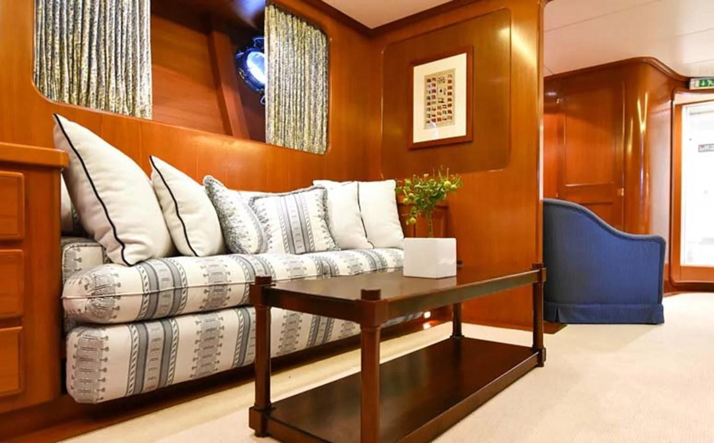 a living room with a couch and a coffee table aboard TAMARITA Yacht for Sale