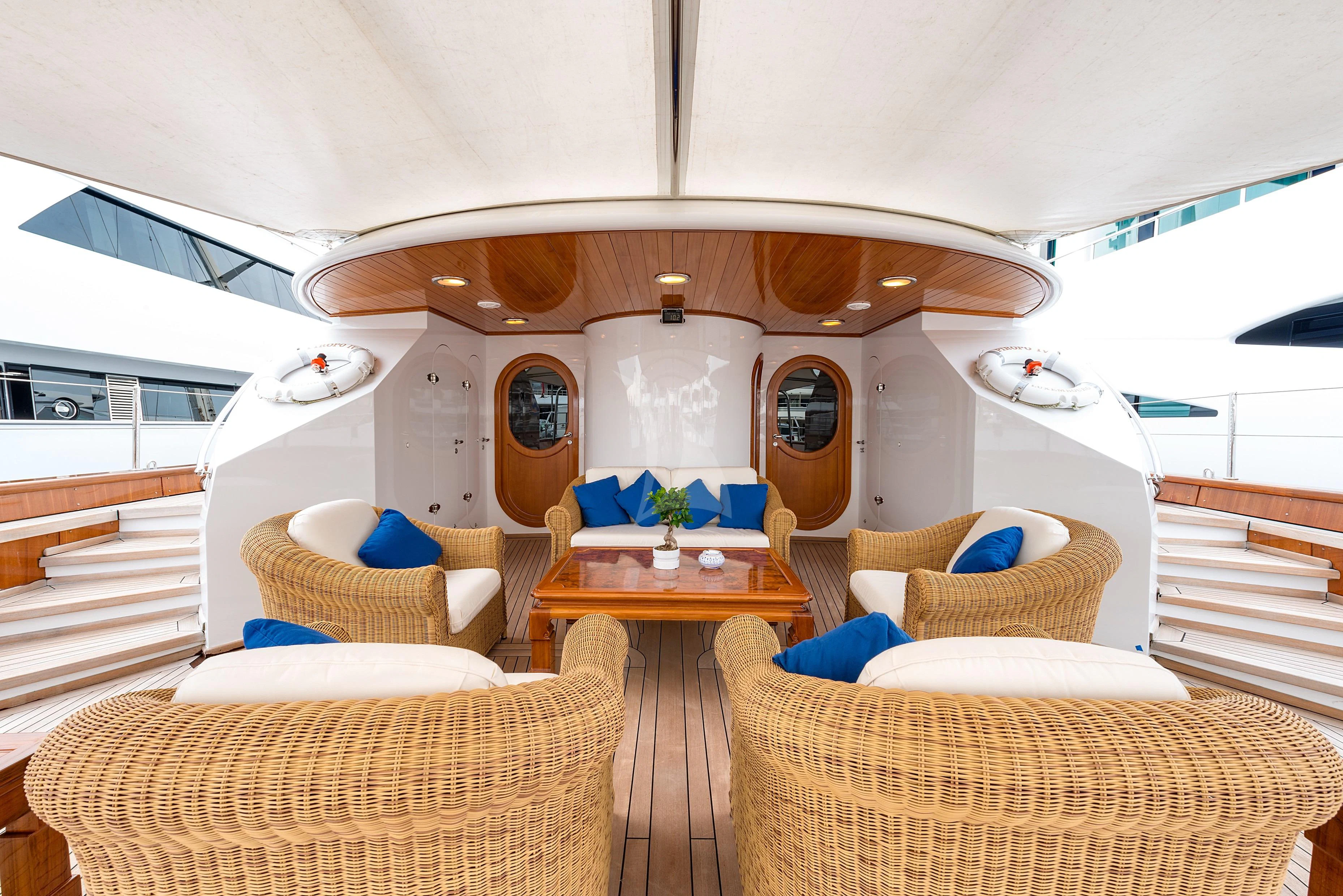 a room with a table chairs and a bed aboard TAMARITA Yacht for Sale