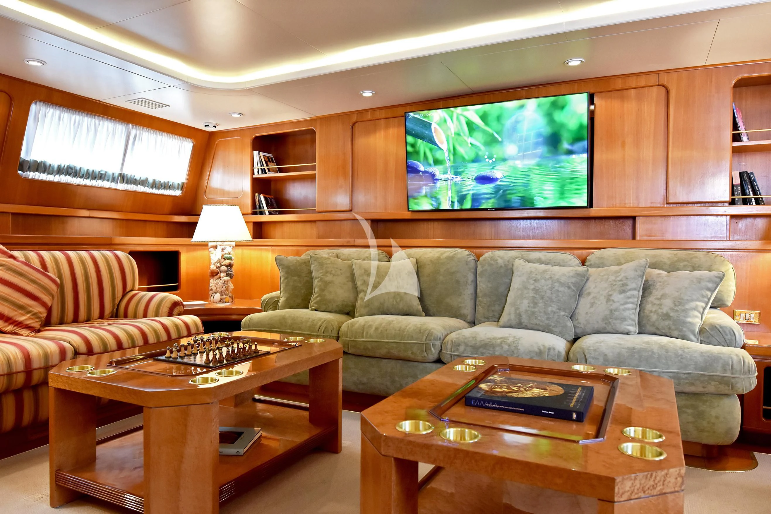 a living room with a couch and a coffee table aboard TAMARITA Yacht for Sale