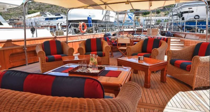a room with couches and tables aboard TAMARITA Yacht for Sale