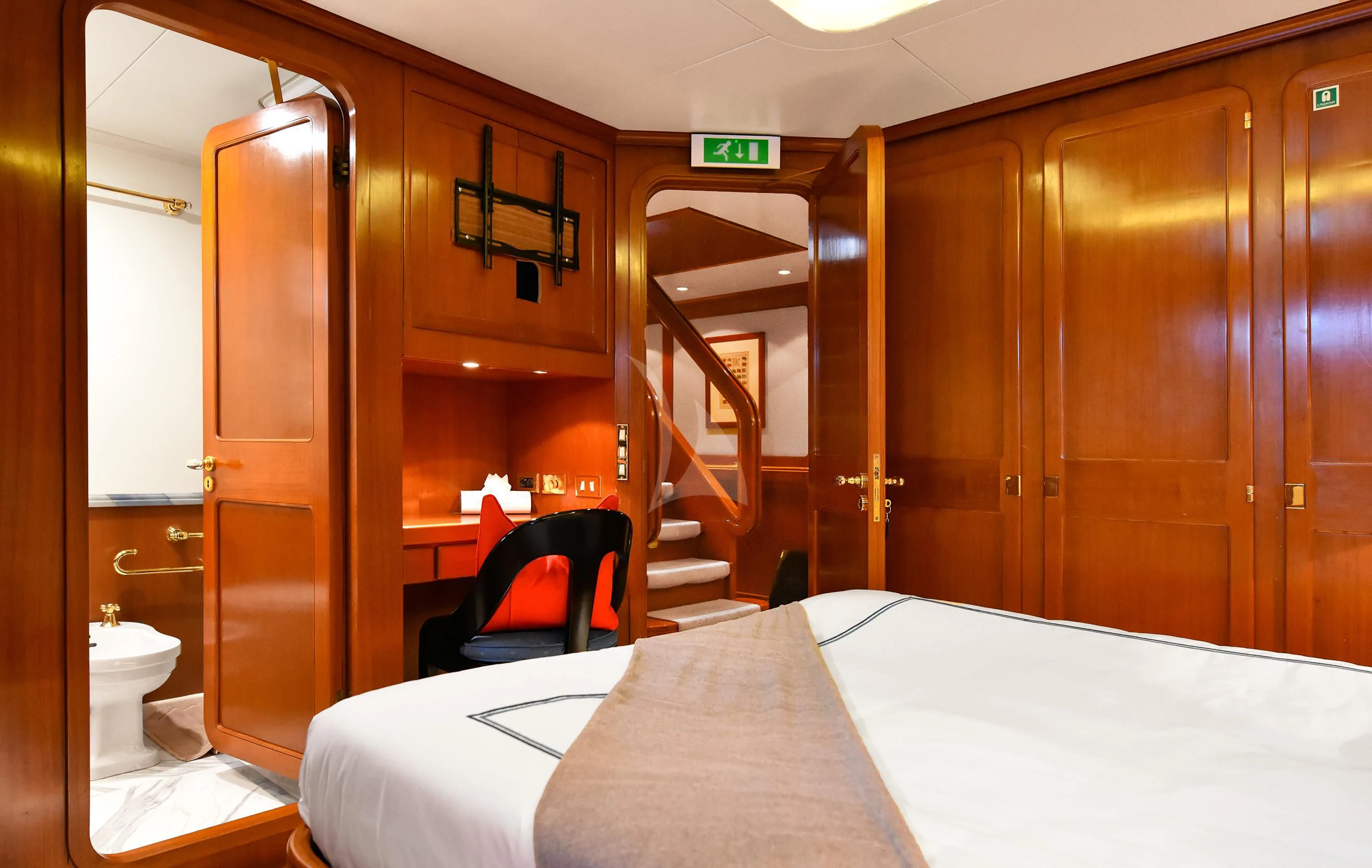 a room with a bed and a chair aboard TAMARITA Yacht for Sale