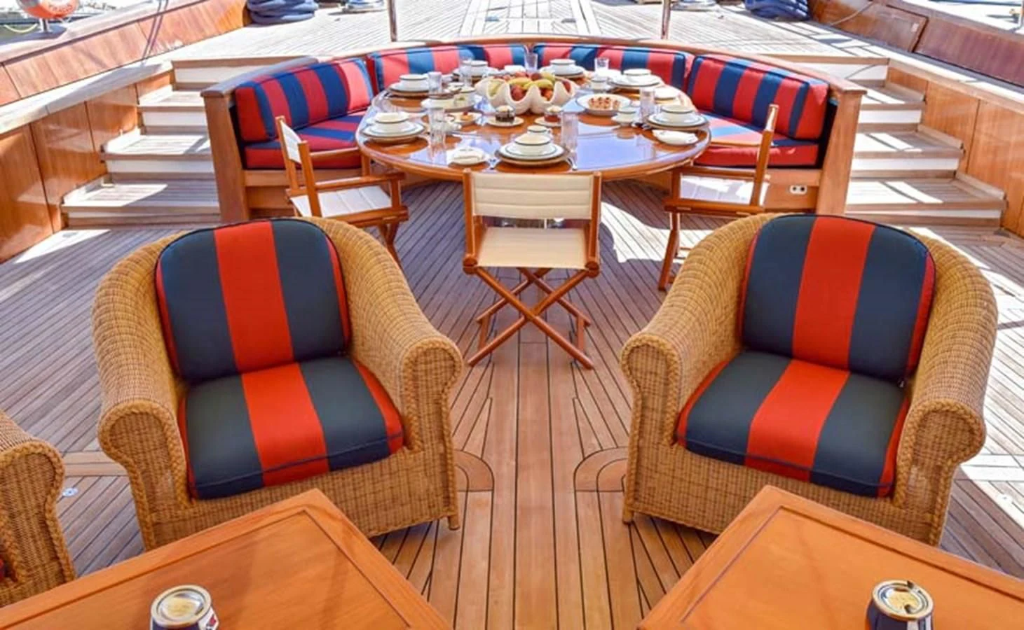 a table with chairs and a couch aboard TAMARITA Yacht for Sale