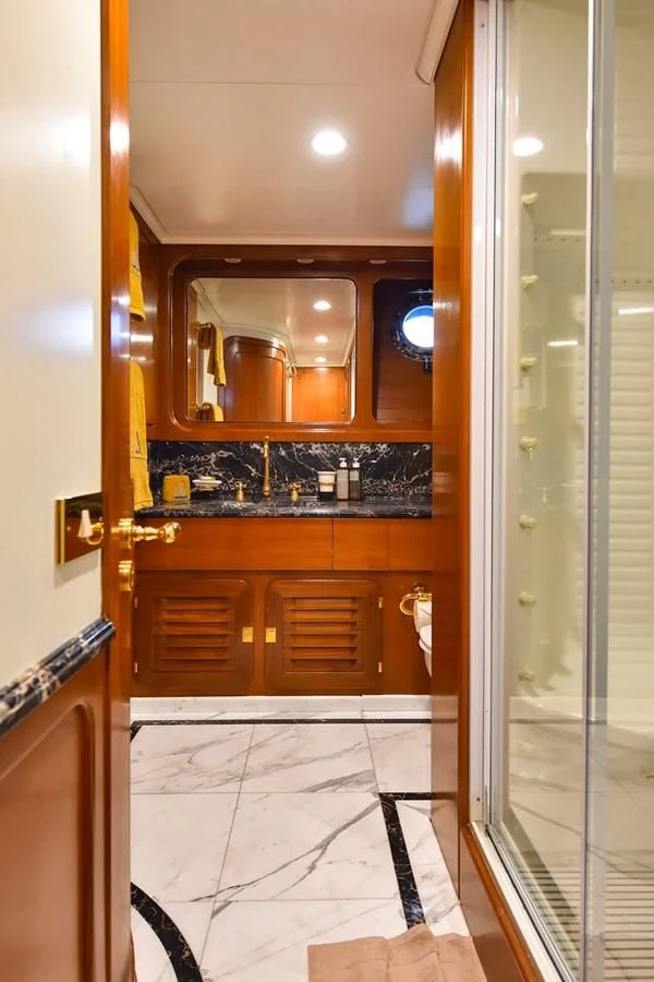 a bathroom with a glass shower aboard TAMARITA Yacht for Sale