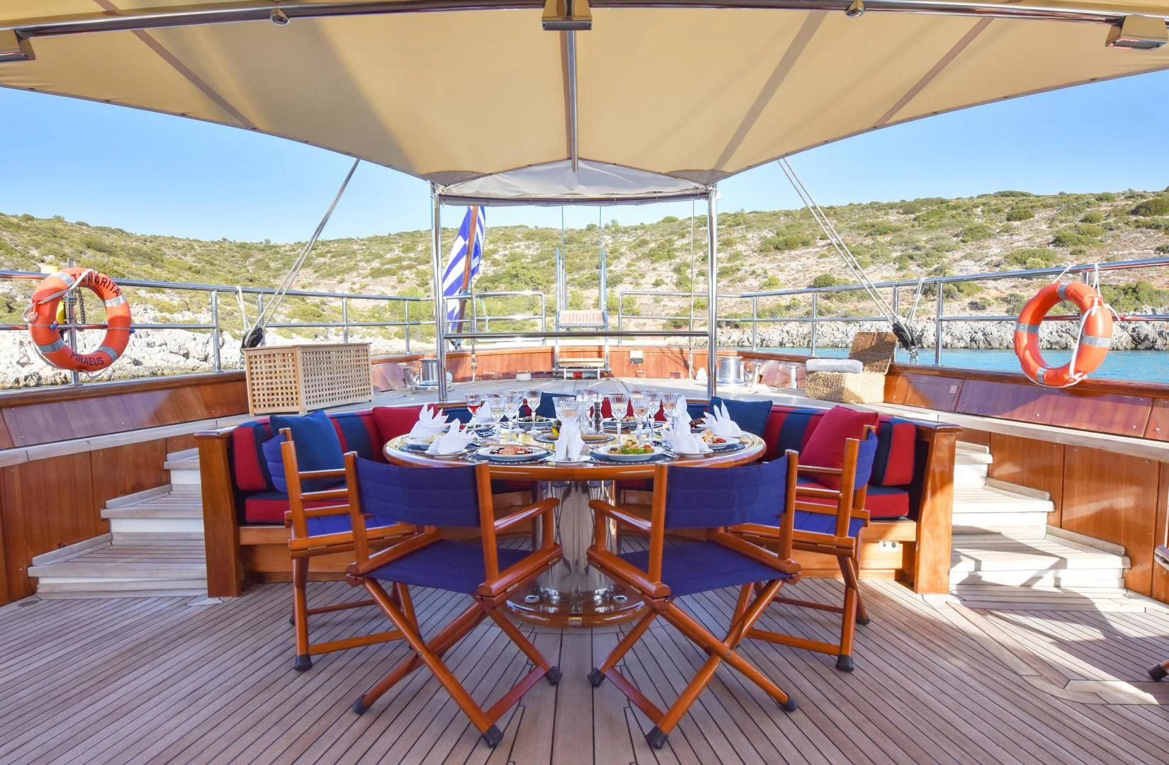a table set up on a deck aboard TAMARITA Yacht for Sale