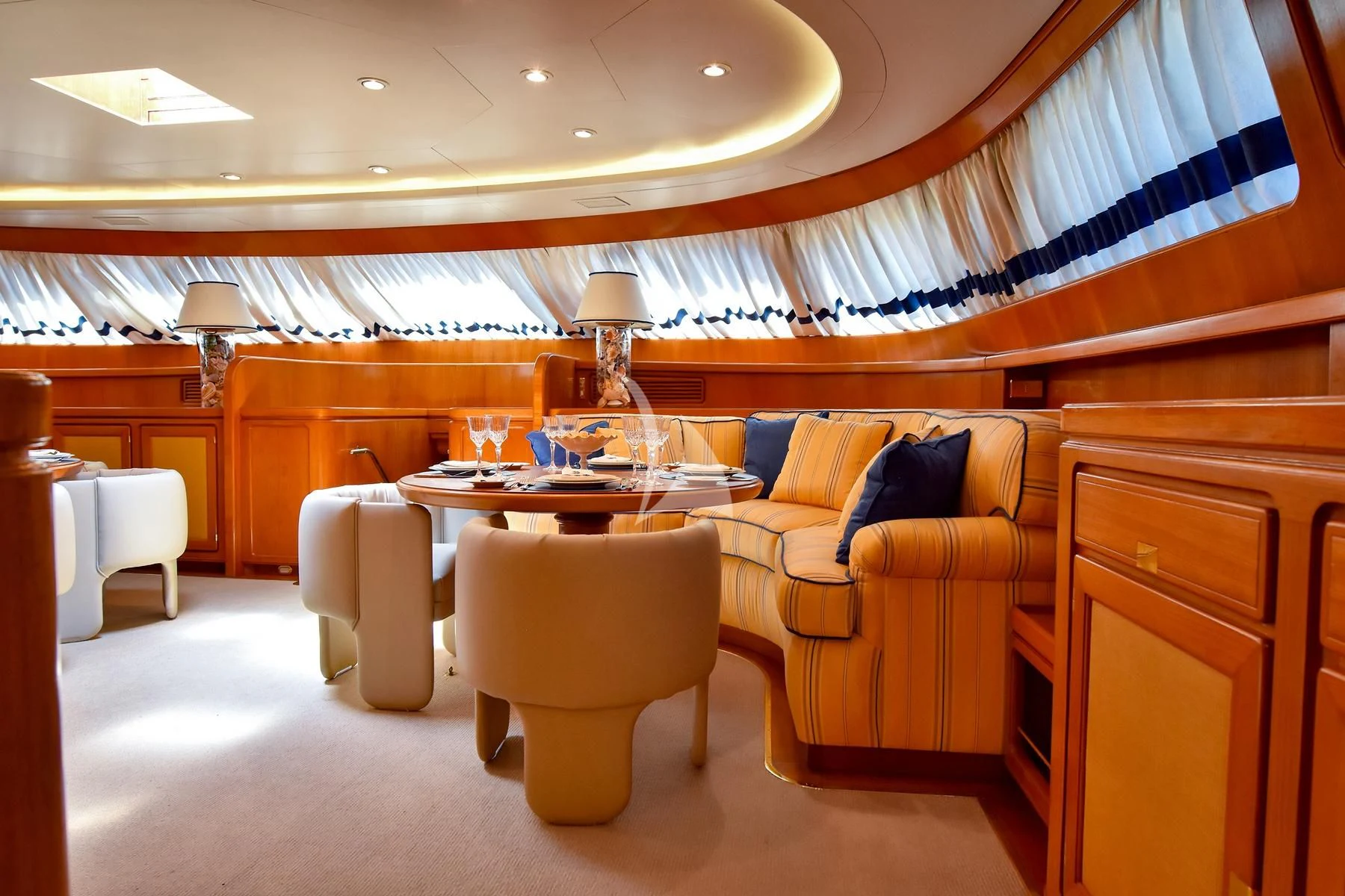 a room with a table chairs and a couch aboard TAMARITA Yacht for Sale