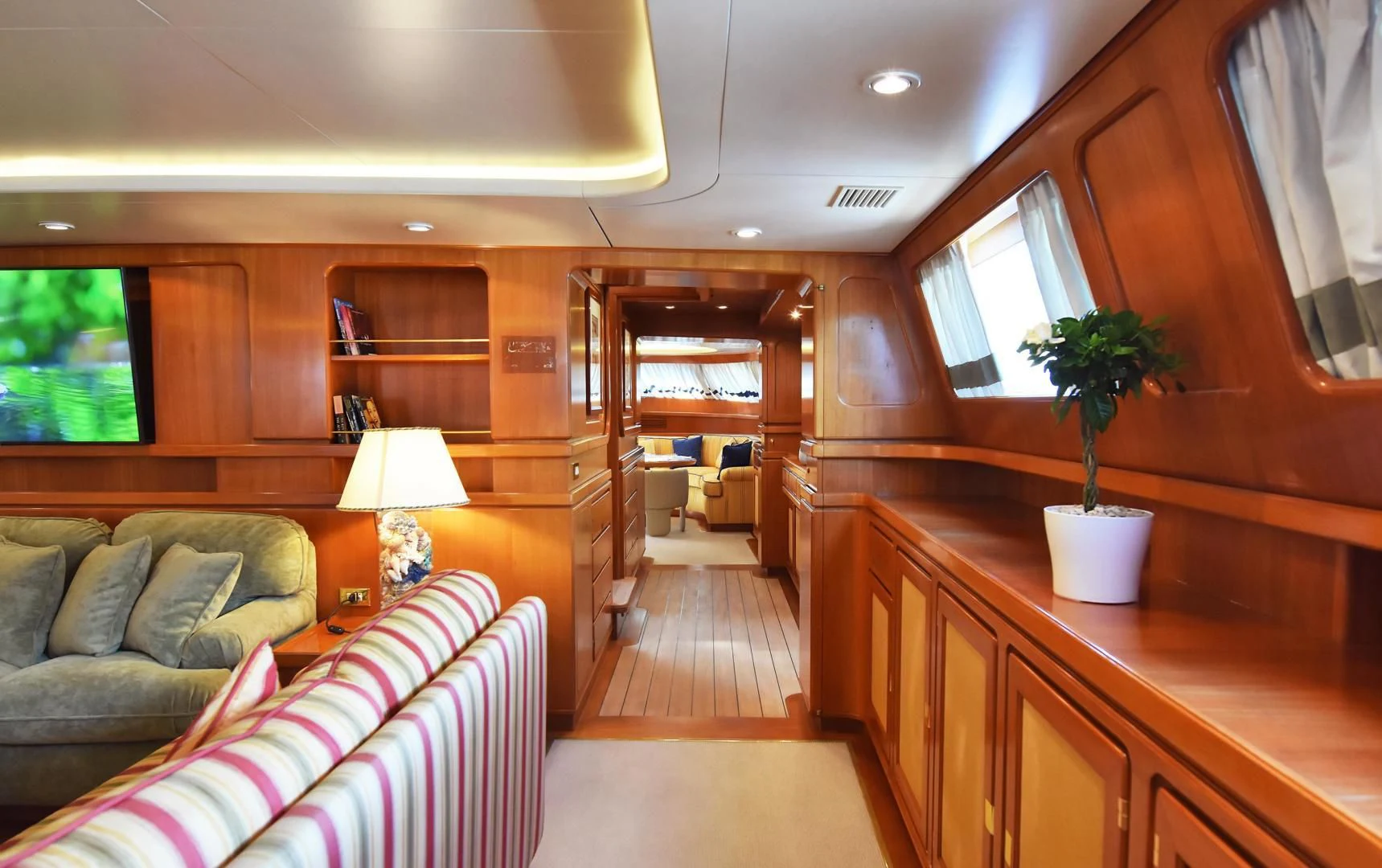 a living room with a couch and a table aboard TAMARITA Yacht for Sale