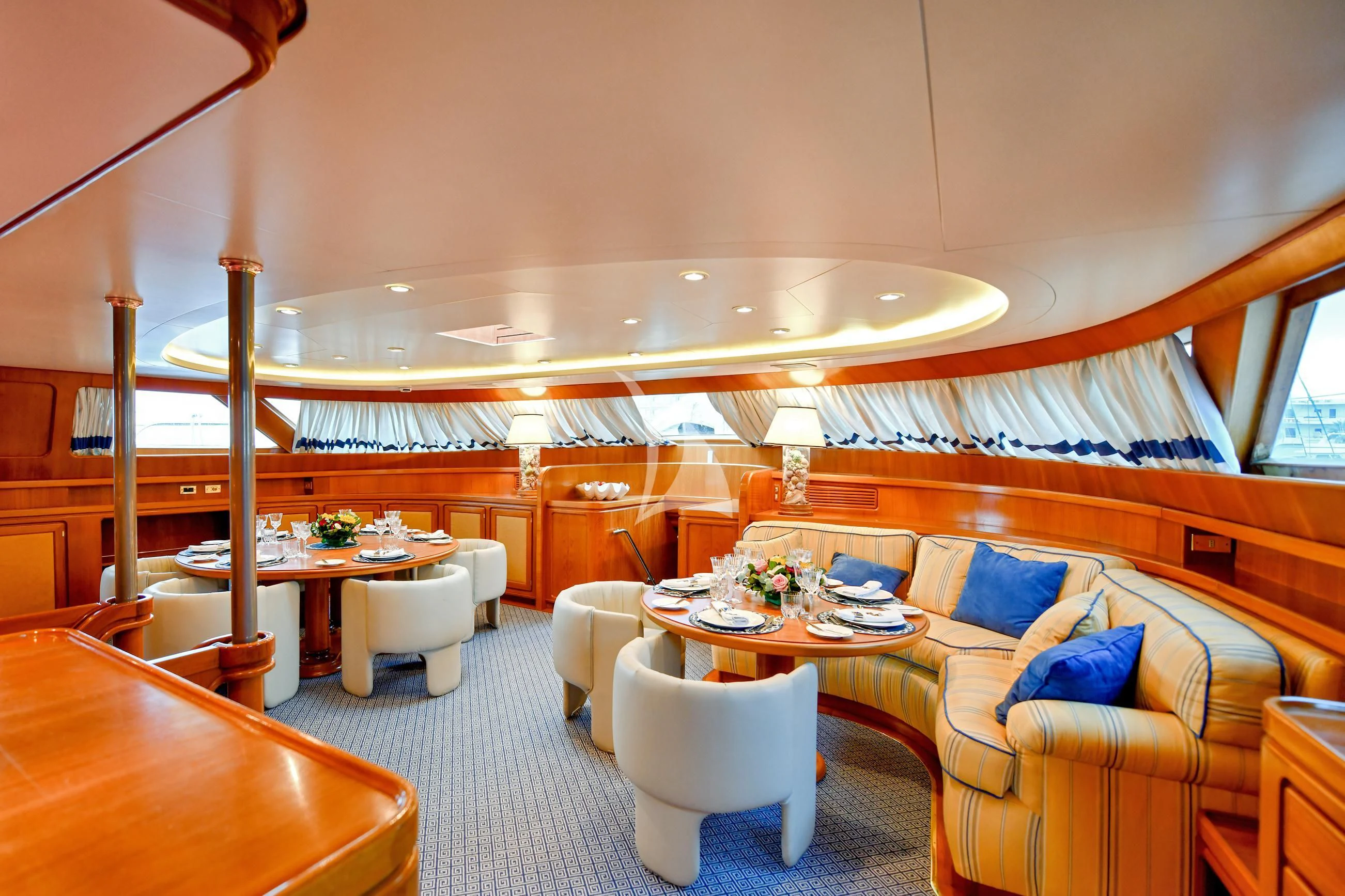 a large room with a couch and a table and chairs aboard TAMARITA Yacht for Sale