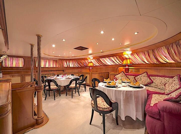 a room with a table and chairs aboard TAMARITA Yacht for Sale