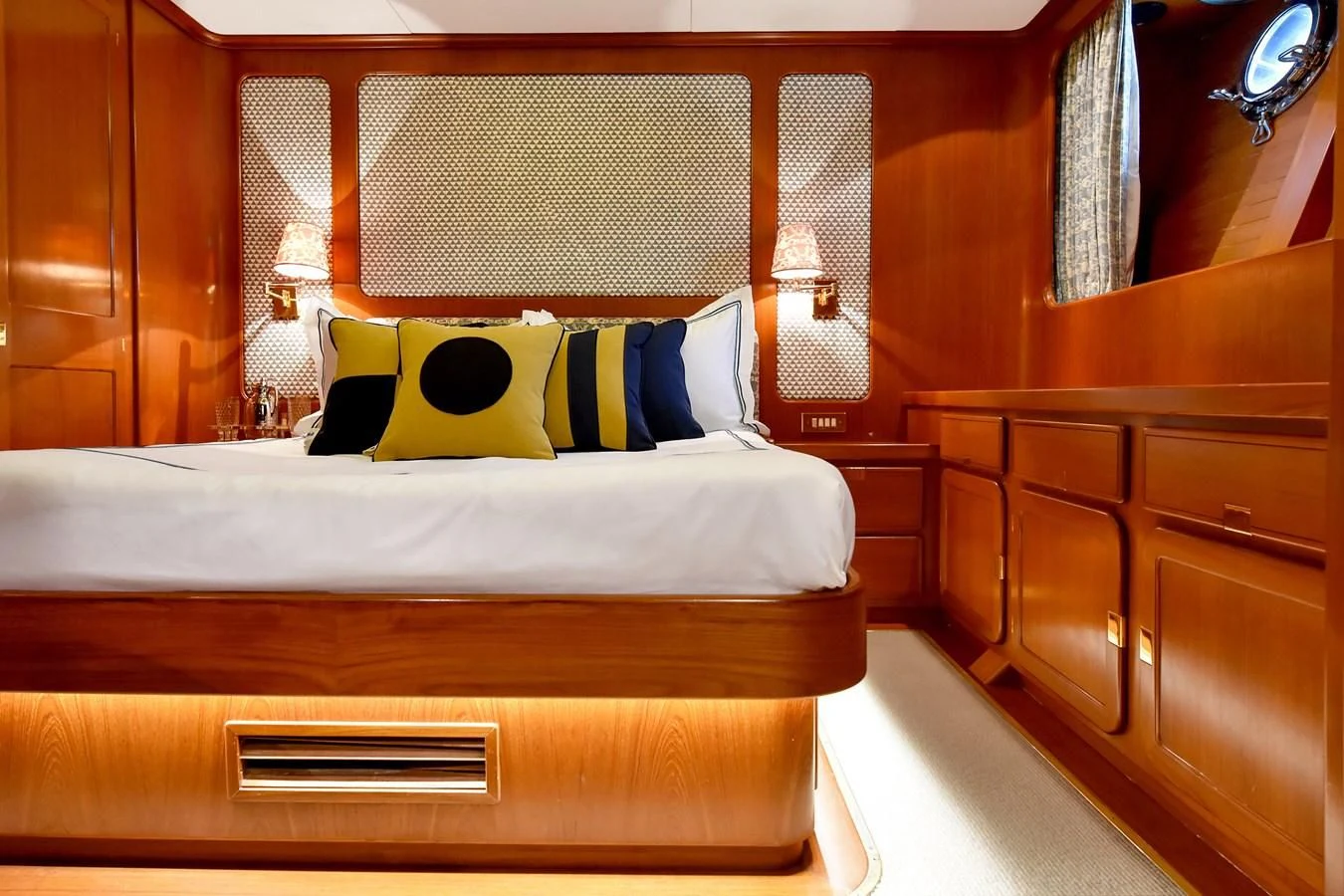 a bed with a white sheet and pillows aboard TAMARITA Yacht for Sale