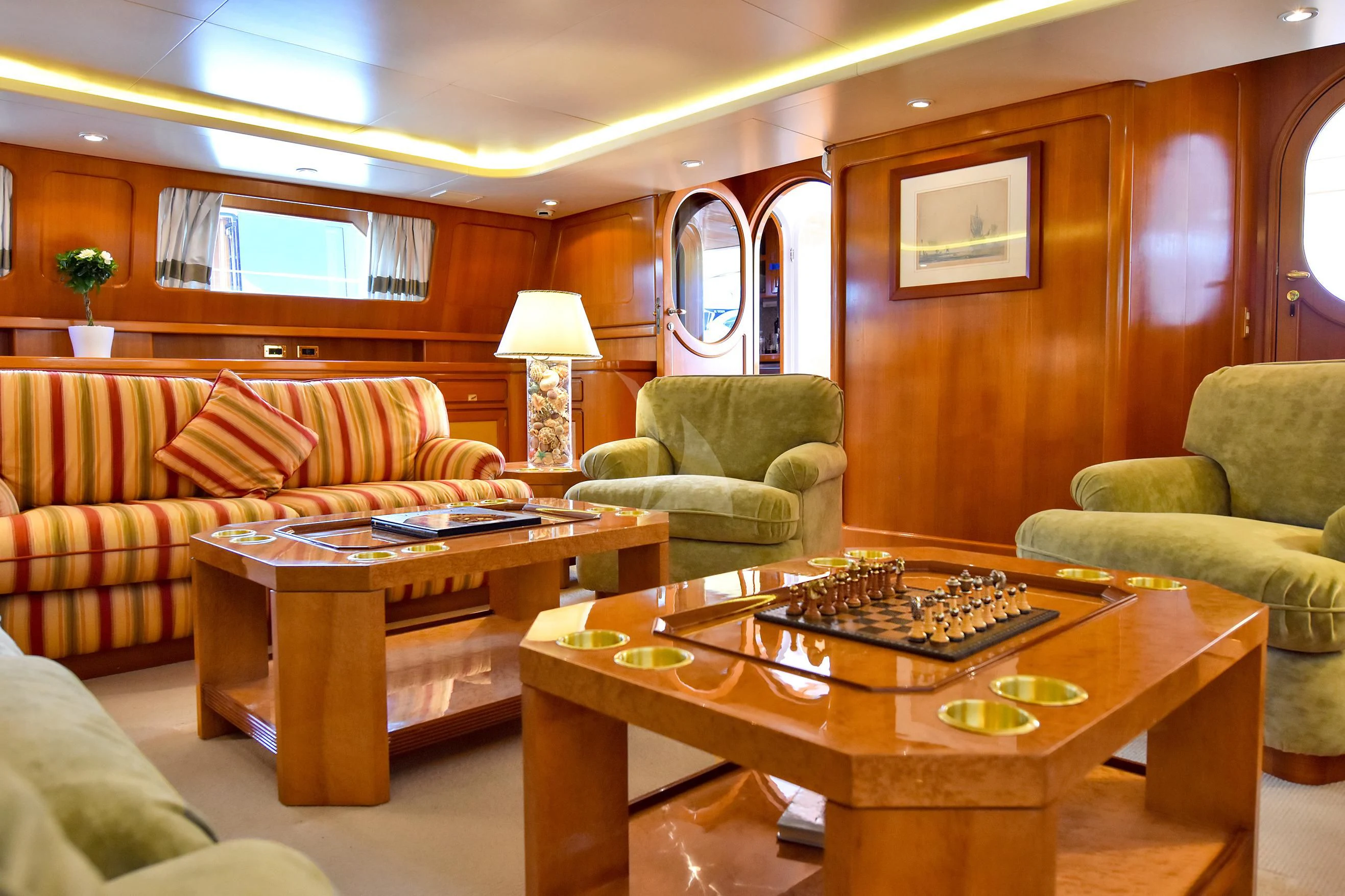 a living room with a couch and a coffee table aboard TAMARITA Yacht for Sale