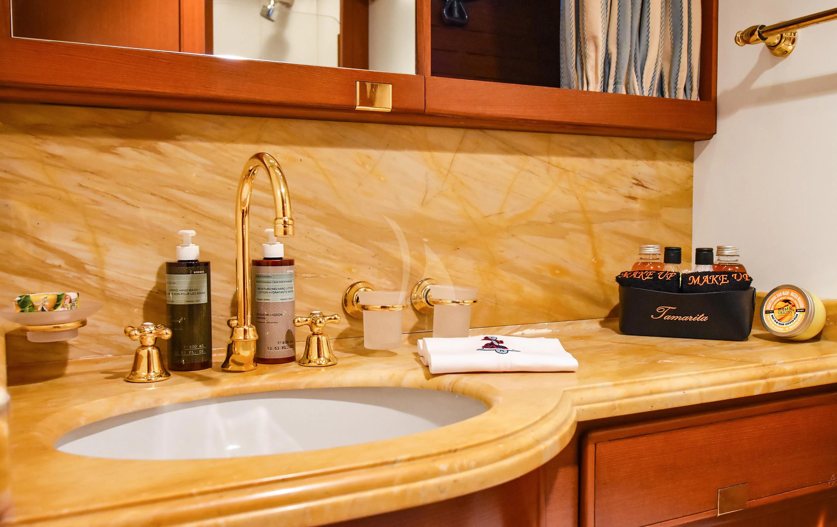a bathroom with a sink and a mirror aboard TAMARITA Yacht for Sale