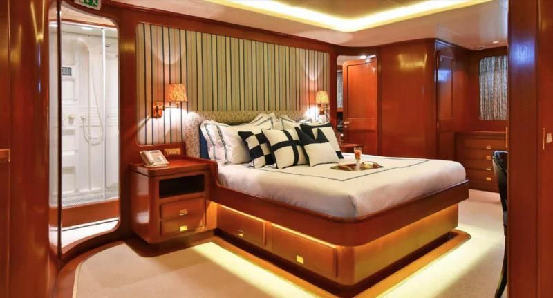 a bed in a room aboard TAMARITA Yacht for Sale