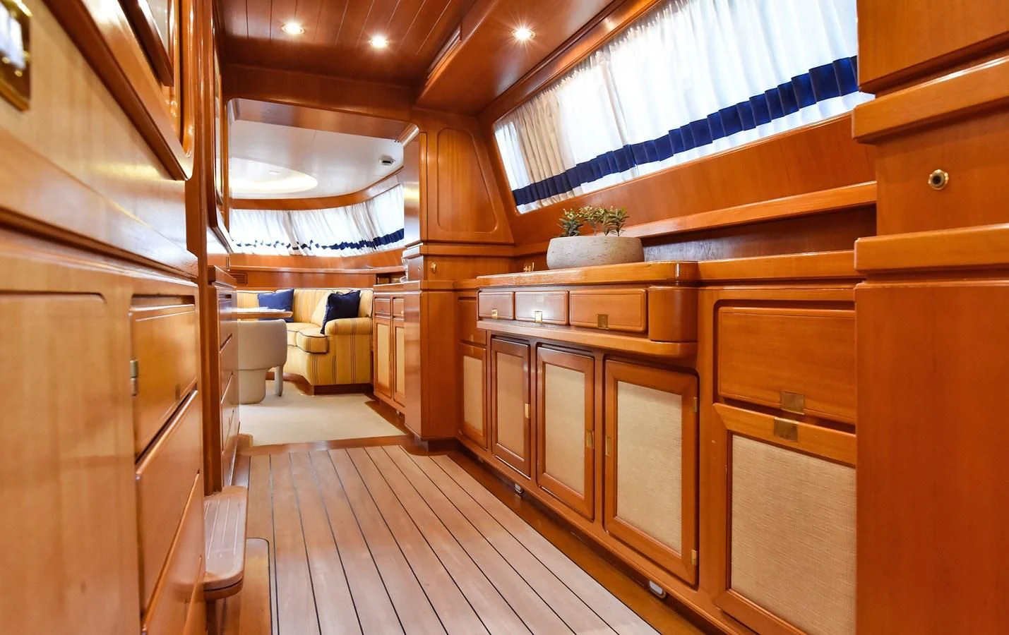 a room with wooden furniture aboard TAMARITA Yacht for Sale